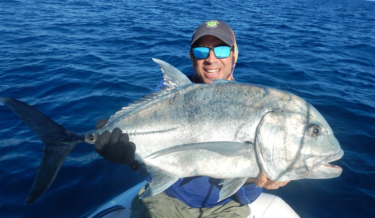 Michael holding a giant trevally off Fanning Island