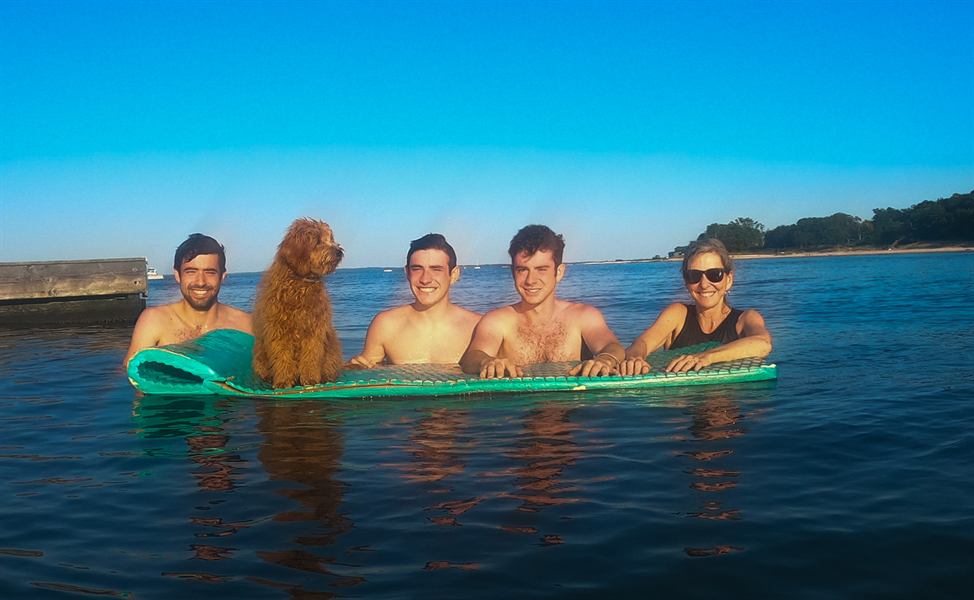 Hobie riding a float in the water with the family